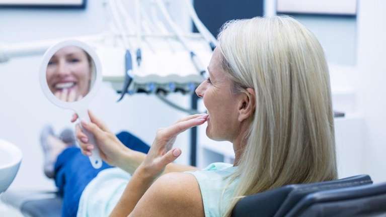 woman checking smile with dental veneers in Mona Vale NSW 