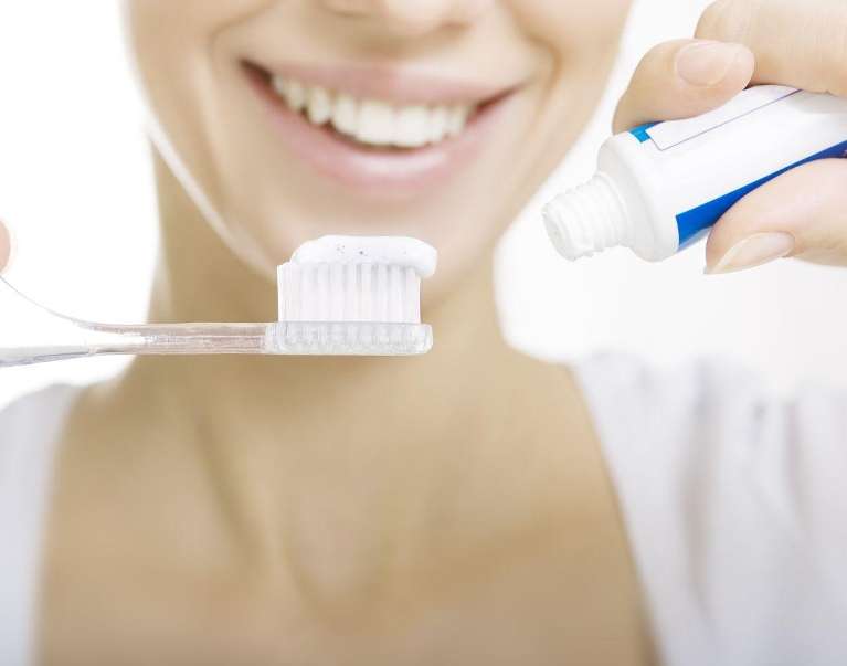woman using baking soda toothpaste in Mona Vale NSW