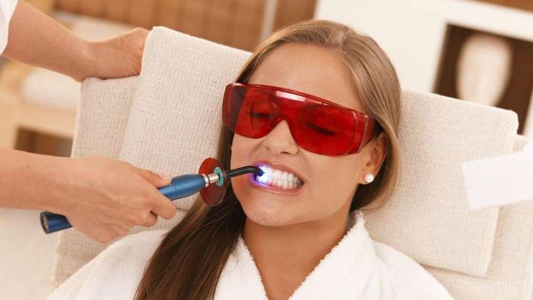 Female patient receiving laser teeth cleaning in Mona Vale